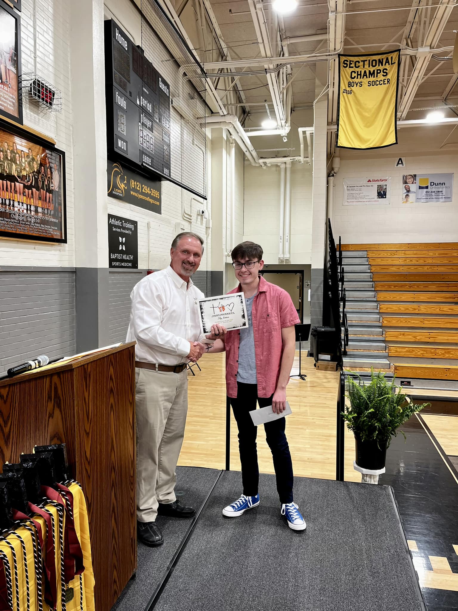 Henryville student accepting scholarship.